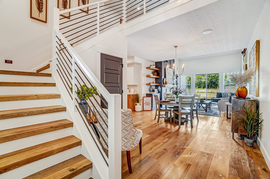Open home interior featuring a white oak stairway and hardwood floor