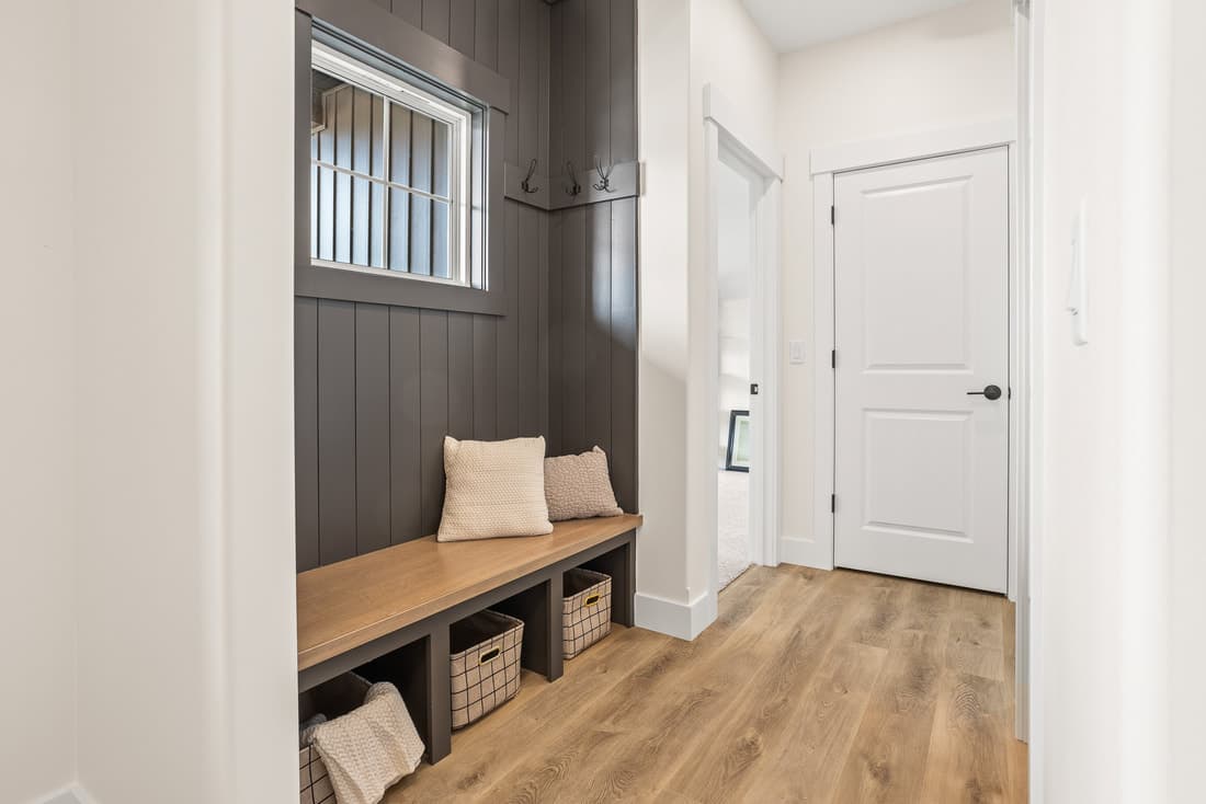 Mudroom bench, wall paneling, and interior door