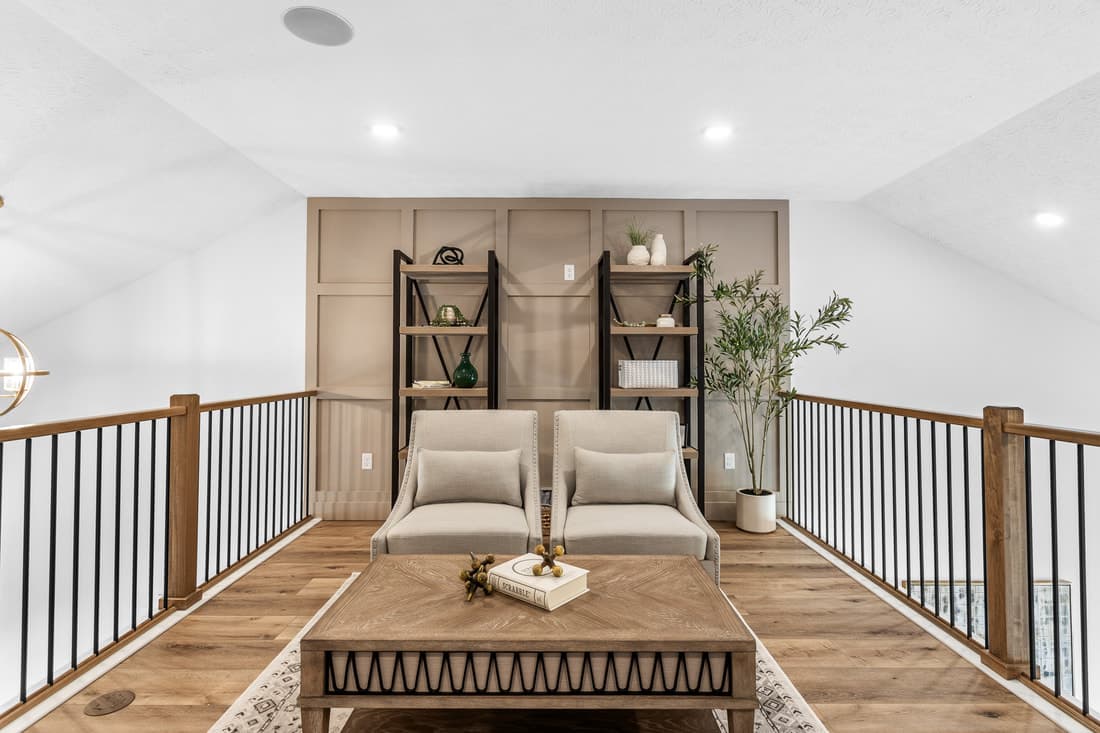 Loft landing with wood handrail and black iron balusters