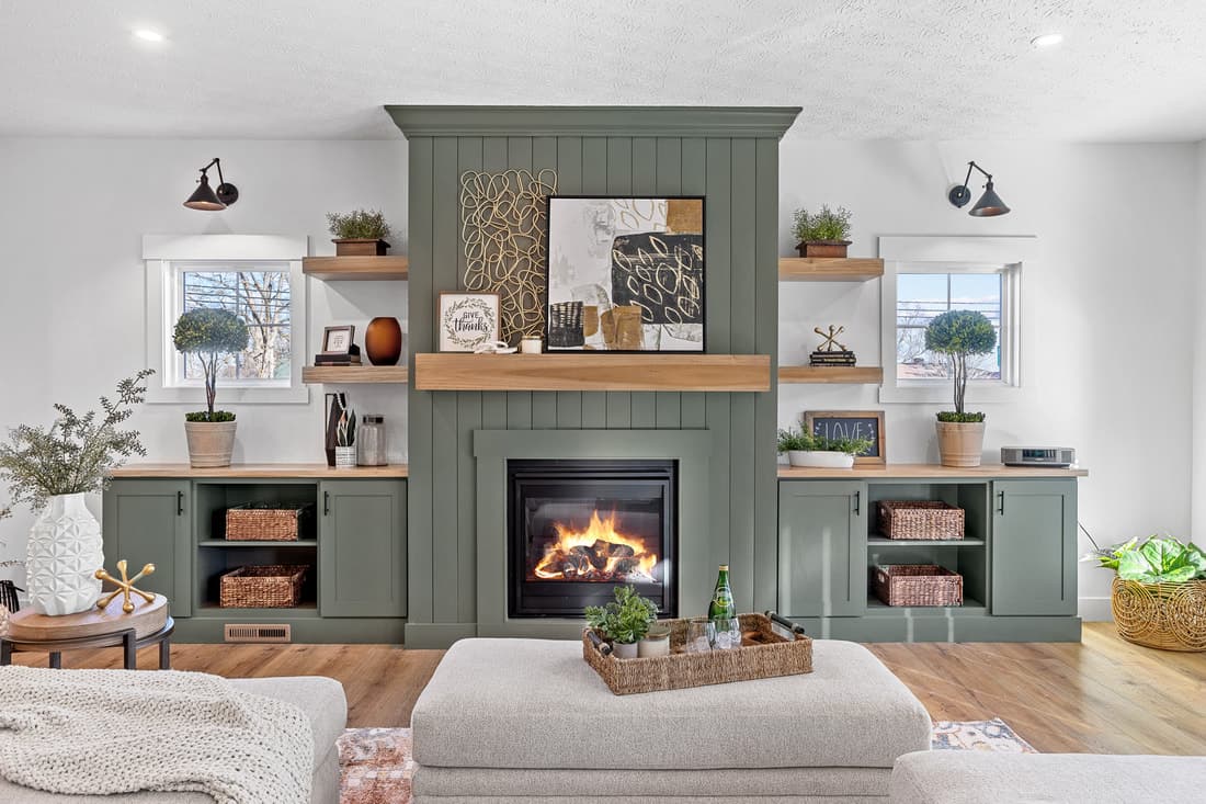 Painted fireplace mantel with symmetrical built-in cabinetry