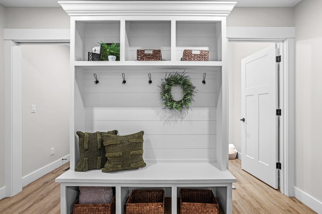Built-in entry bench with shelf, hooks, and adjacent doors
